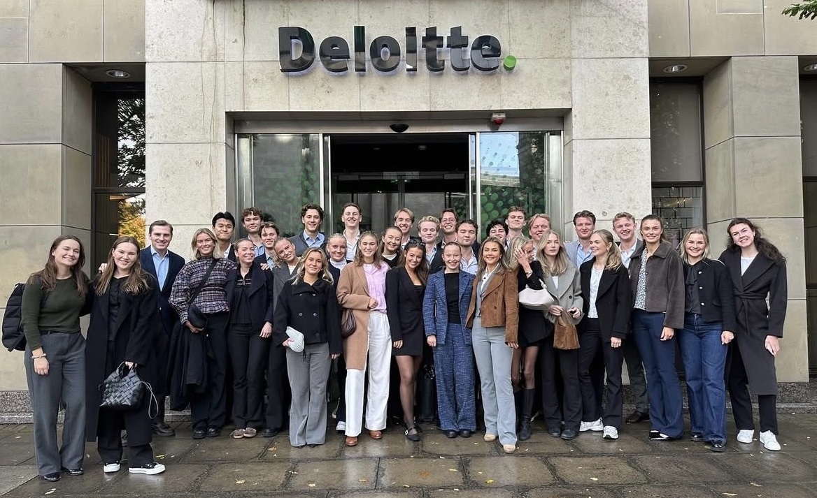 The Business Committee standing in front of Deloitte